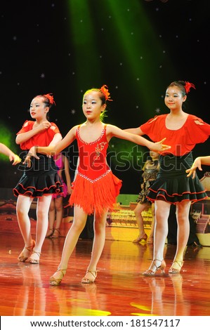 SHIJIAZHUANG CITY, CHINA - JULY 7: On July 7, 2012 in Shijiazhuang City, China Youth Arts Festival Unidentified group of cute kids performing  Unrestrained rumba dance.