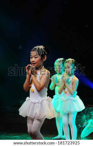 SHIJIAZHUANG CITY, CHINA - JULY 7: On July 7, 2012 in Shijiazhuang City, China Youth Arts Festival Unidentified group of cute kids performing dance drama.