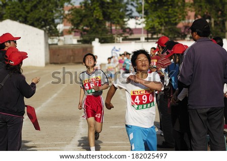 BAIXING COUNTY, CHINA - MAY 12, 2011: Baixiang County Middle School Track Meet held in May 12, 2011. Unidentified Student athletes worked hard toward the finish line.
