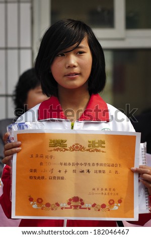 XINGTAI CITY, CHINA - May, 2012: In the May 27, 2011, a school for students winning awards and certificates The award-winning unidentified students are very happy and proud.