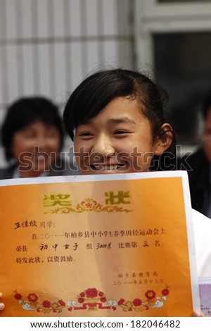 XINGTAI CITY, CHINA - May, 27 2011: In the May 27, 2011, a school for students winning awards and certificates The award-winning unidentified students are very happy and proud.
