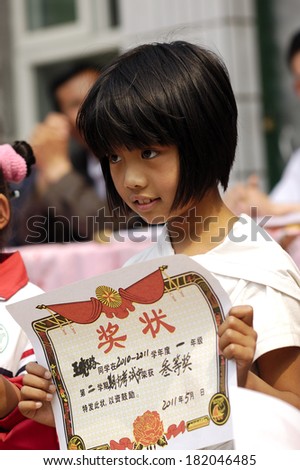 XINGTAI CITY, CHINA - May 27,2011: In the May 27, 2011, a school for students winning awards and certificates The award-winning unidentified students are very happy and proud.
