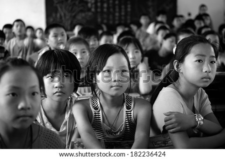 Baixiang County, China - June  12: In June 12, 2011, a school arrange for students to watch on electrical safety feature film. Unidentified student was hooked.