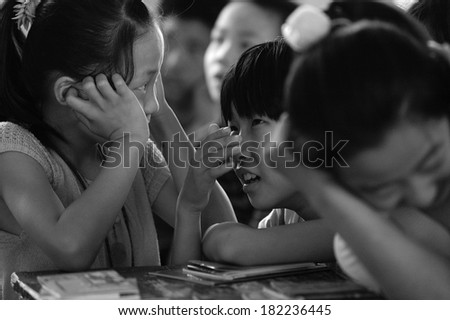 Baixiang County, China - June  12: In June 12, 2011, a school arrange for students to watch on electrical safety feature film. Unidentified student was hooked.