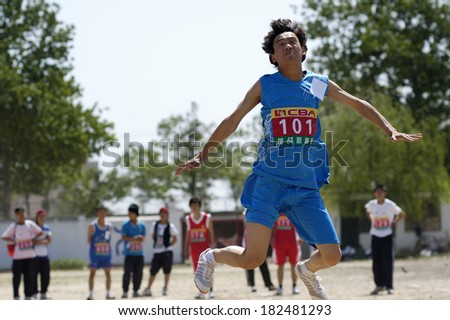 Xingtai City, China - May 12: In May 12, 2011, baixiang County Middle School Games were held. Unidentified student athletes in the long jump worked hard to win the game.