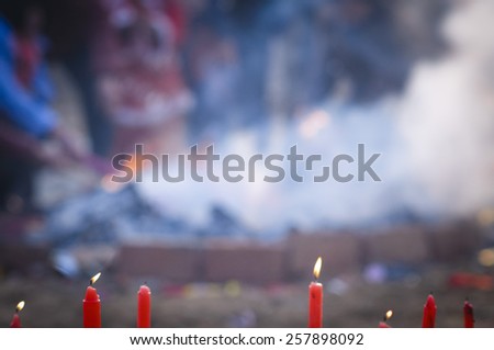 In the Chinese countryside vulcan, the villagers in the burn incense worshipping Buddha. blur