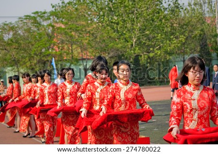 Hengshui city - China, April 2015: on April 25, 2015, Hengshui high school by rites. Taking. Unidentified miss manners in qipao tidy and beautiful.