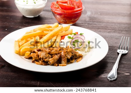 Kebab plate with french fries fresh cole slaw and onions