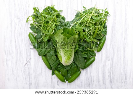 Green vegetables in heart shape on a background