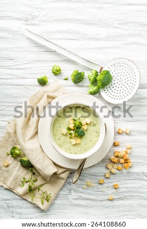 fresh broccoli soup with croutons and herbs