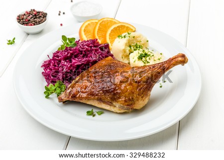 Roast duck with dumplings, red cabbage and oranges