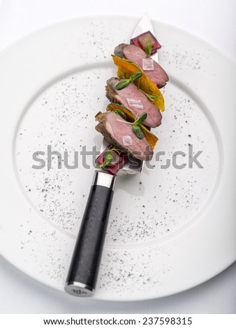 roasted meat on the knife