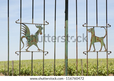 Wrought iron gate decorated with a cock and a dog, Borba, Alentejo, Portugal
