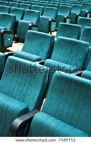 Rows of chairs in an empty auditorium