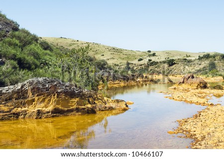 Detail of polluted river by chemicals near an abandoned mine
