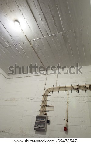 Industrial basement wall with wiring and breaker box
