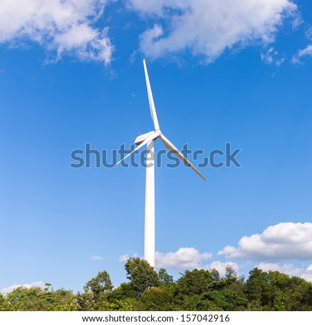 White electric wind mill with clear blue sky