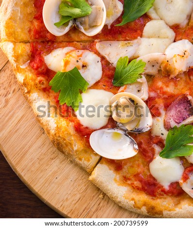 thin crust seafood pizza close up