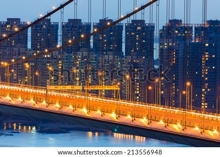 night scene of Tsing Ma bridge light trail residence building
