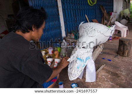 LOEI, THAILAND - JUNE 28 : Painter painting mask in Phi ta khon halloween festival on June 28 2014 in Loei, Thailand