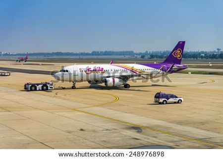 BANGKOK, THAILAND - JANUARY 22 : Thai Smile's airplane waiting for take off at Don Muang airport on January 22, 2015 in Bangkok, Thailand.