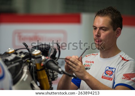 BURIRAM - MARCH 20 : Pata Honda World Superbike Team mechanic inspecting race bike in pit at Chang International Circuit on March 20 2015, Buriram, Thailand