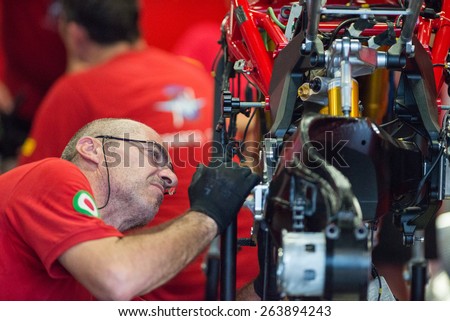 BURIRAM - MARCH 20 : MV Agusta Reparto Corse mechanic inspecting race bike in pit at Chang International Circuit on March 20 2015, Buriram, Thailand