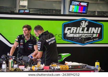 BURIRAM - MARCH 20 : Grillini SBK Team mechanic inspecting race bike in pit at Chang International Circuit on March 20 2015, Buriram, Thailand