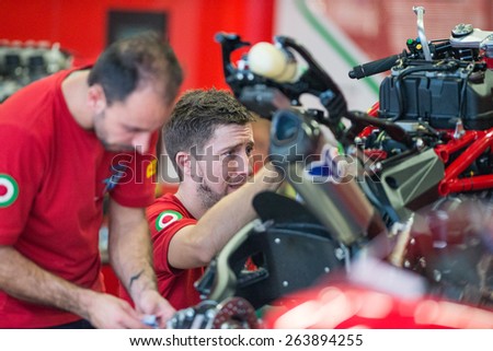 BURIRAM - MARCH 20 : MV Agusta Reparto Corse mechanic inspecting race bike in pit at Chang International Circuit on March 20 2015, Buriram, Thailand