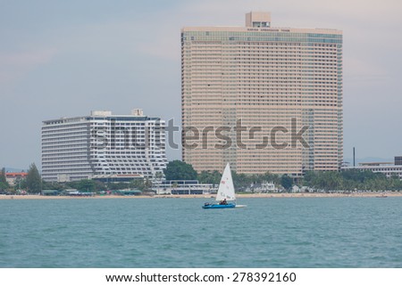 JOMTIEN, THAILAND - MAY 01 : Laser class ship sailing front of Marina Tower in Top of the Gulf Regatta event at Jomtien beach Pataya May 01, 2015