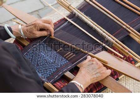 HAINAN - CHINA, MAY 11 : Unidentified hill tribe weaving traditional clothes pattern in Hainan China on May 11,2015