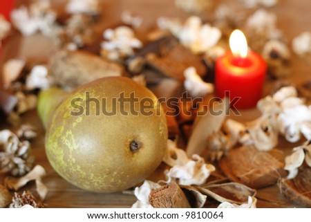 Pear,dried plants and burning candle