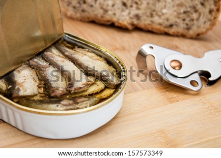 Sprats in can, can opener and bread