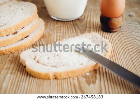 sliced bread, milk and egg on wooden surface
