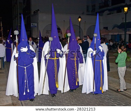 ALGECIRAS, SPAIN - APRIL 8: Bearers at Holy Thursday night Procession in Algeciras,  April 8, 2009. The conical hoods evokes an approach of the bearer to the sky, interpreted like salvation place.