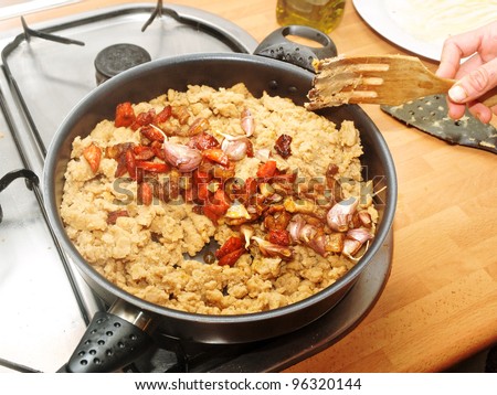 Spanish cuisine.Bread and red sausage with meat. Migas con chorizo y panceta  A typical spanish meat of the country people