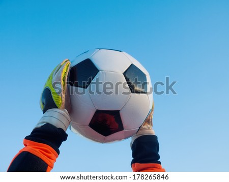 goalkeeper catches football / soccer-ball