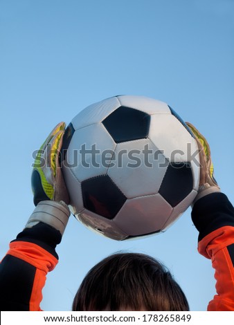 goalkeeper catches football / soccer-ball