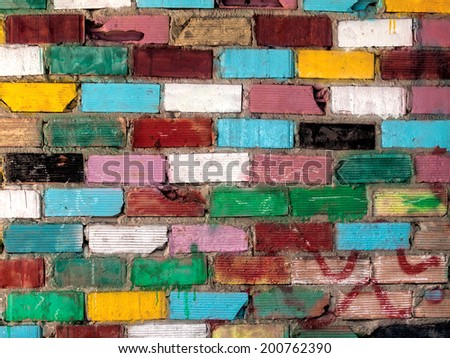 Colorful grungy brick wall with colored bricks