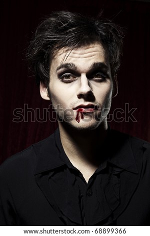 Hot male Vampire, blood on one side of his mouth.