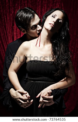 Vampire is biting a beautiful woman