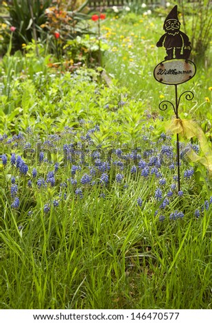 Garden in spring and a sign that says \