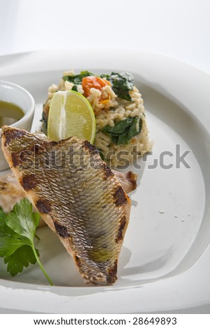 Grilled fish with rice and lemon sauce