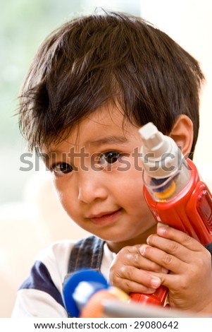 Young boy with a drill toy