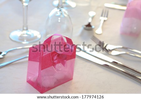 Pretty decorative pink gift or party favour for a guest on a formal table setting celebrating a festive occasion or party