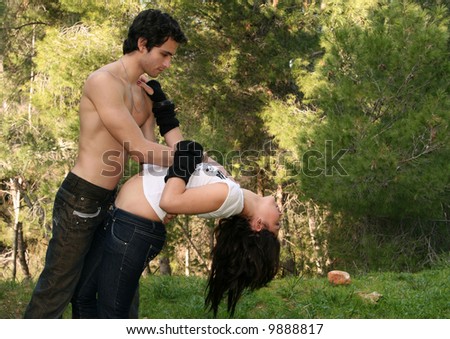 Young couple in love dancing in the woods