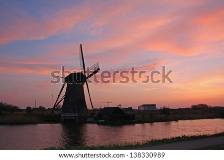Typical Netherlands  landscape with windmill at sunset