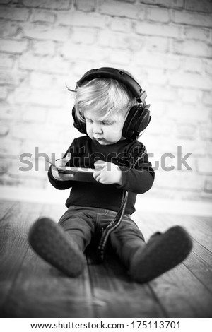 Baby wearing big black headphones