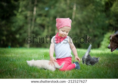 Little girl with large dog and cats
