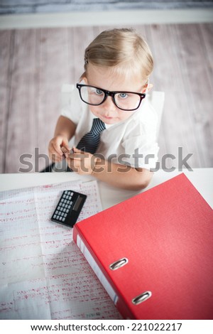 Little business person eating chocolate at work